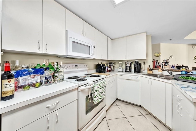 2351 Douglas Rd Unit 1204, Miami, FL 33145 - kitchen with white appliances, a sink, light countertops, light tile patterned floors, and white cabinetry
