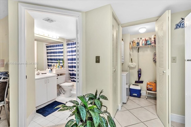 2351 Douglas Rd Unit 1204, Miami, FL 33145 - full bathroom with a closet, vanity, tile patterned flooring, toilet, and washing machine and dryer