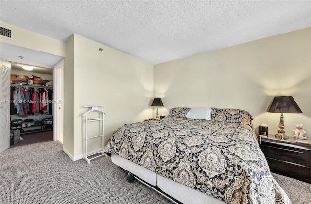 2351 Douglas Rd Unit 1204, Miami, FL 33145 - bedroom featuring carpet floors, a closet, a textured ceiling, and a walk in closet