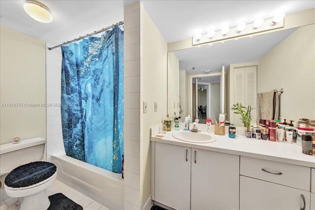 2351 Douglas Rd Unit 1204, Miami, FL 33145 - bathroom with vanity, shower / bath combo with shower curtain, toilet, tile patterned floors, and a closet