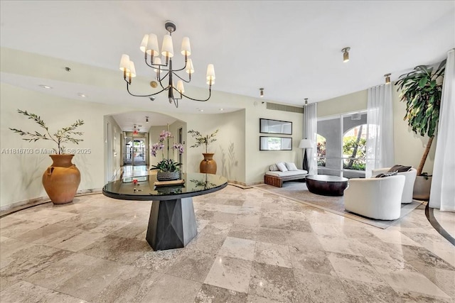 2351 Douglas Rd Unit 1204, Miami, FL 33145 - foyer entrance with stone tile floors, a chandelier, and baseboards
