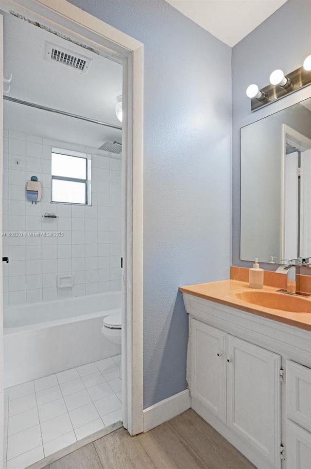 6555 W Broward Blvd Unit 412, Plantation, FL 33317 - bathroom with vanity, toilet, shower / tub combination, baseboards, and wood finished floors