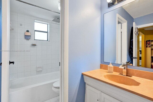 6555 W Broward Blvd Unit 412, Plantation, FL 33317 - bathroom featuring vanity, toilet, bathtub / shower combination, tile patterned flooring, and a textured wall