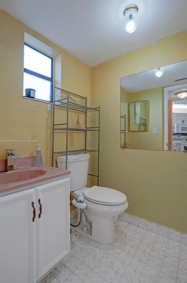 6555 W Broward Blvd Unit 412, Plantation, FL 33317 - half bathroom featuring vanity and toilet