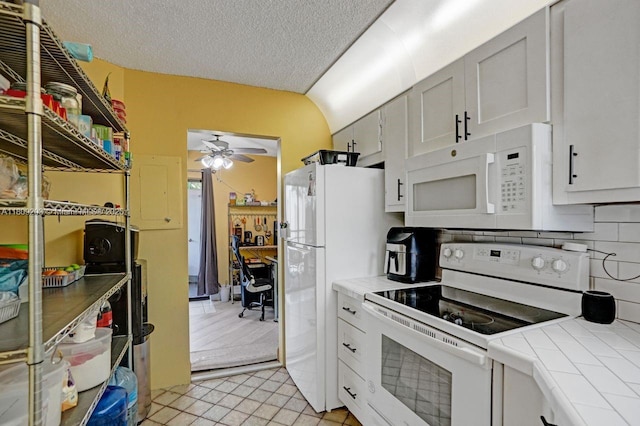 6555 W Broward Blvd Unit 412, Plantation, FL 33317 - kitchen featuring white appliances, tile countertops, a ceiling fan, a textured ceiling, and light tile patterned flooring