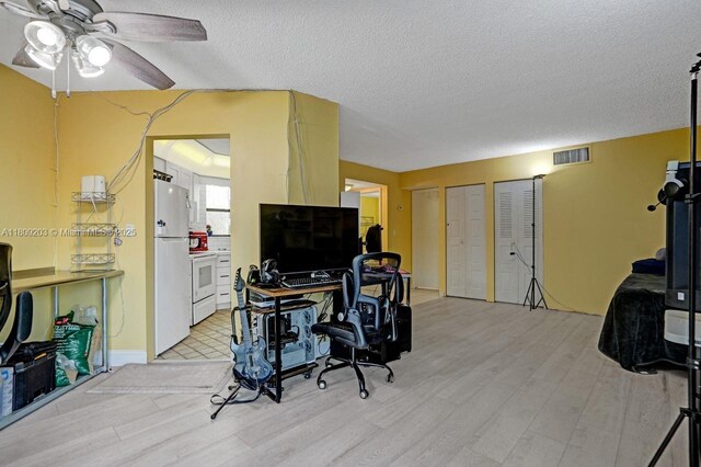 6555 W Broward Blvd Unit 412, Plantation, FL 33317 - office with light wood-type flooring, a ceiling fan, and a textured ceiling