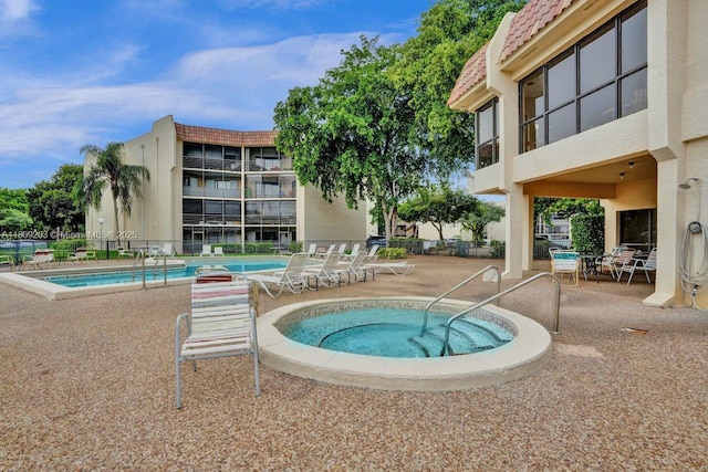 6555 W Broward Blvd Unit 412, Plantation, FL 33317 - community pool featuring a patio area and a hot tub