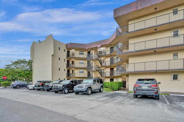 6555 W Broward Blvd Unit 412, Plantation, FL 33317 - view of apartment building / complex featuring uncovered parking