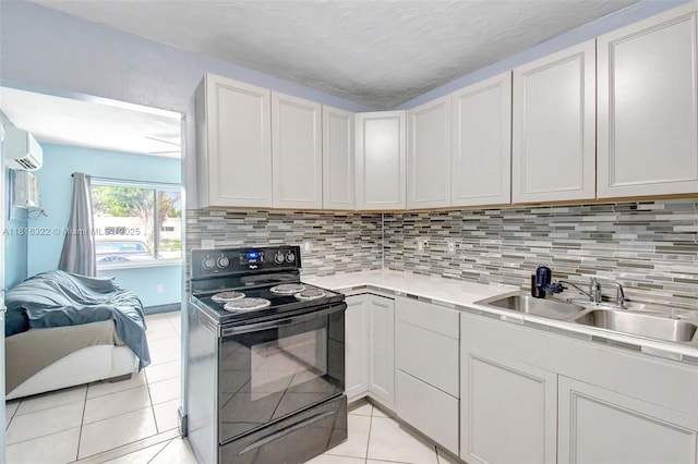 6336 SW 22nd St, Miramar, FL 33023 - kitchen featuring black electric range, a sink, light tile patterned flooring, and decorative backsplash