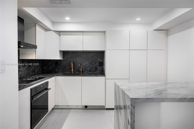 4000 Towerside Ter Unit 804, Miami, FL 33138 - kitchen with black appliances, wall chimney range hood, white cabinetry, backsplash, and recessed lighting