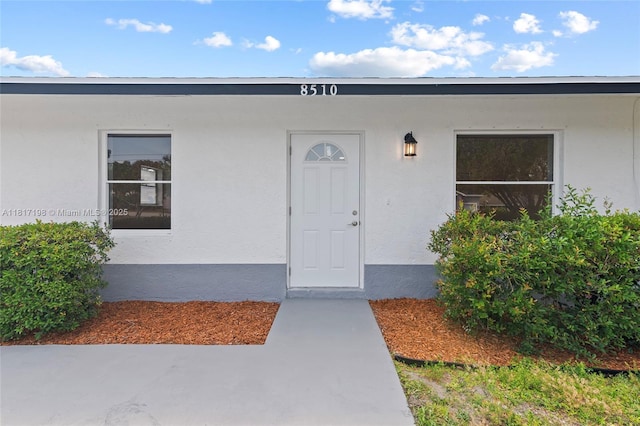 8510 SE Citrus Way, Hobe Sound, FL 33455 - view of exterior entry featuring stucco siding