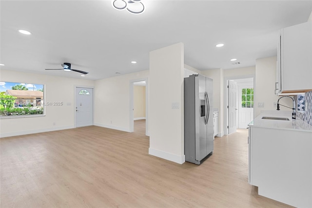 8510 SE Citrus Way, Hobe Sound, FL 33455 - kitchen featuring stainless steel fridge, a sink, light wood finished floors, light countertops, and recessed lighting