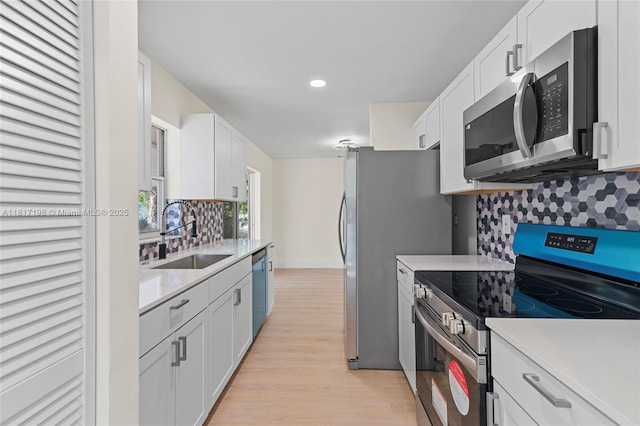 8510 SE Citrus Way, Hobe Sound, FL 33455 - kitchen featuring stainless steel appliances, a sink, light countertops, backsplash, and recessed lighting