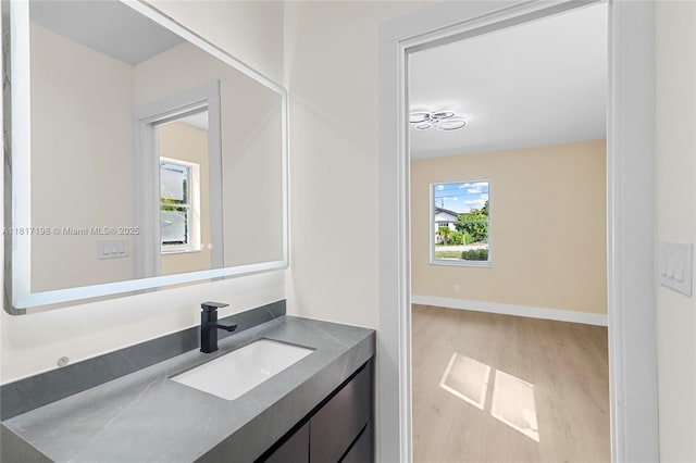 8510 SE Citrus Way, Hobe Sound, FL 33455 - bathroom featuring wood finished floors, vanity, and baseboards
