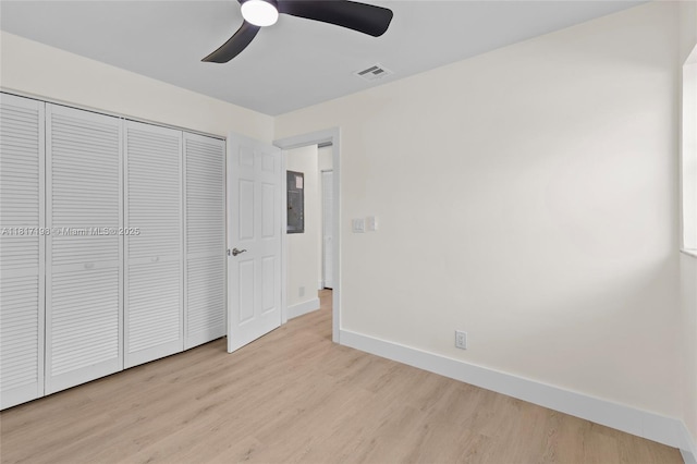 8510 SE Citrus Way, Hobe Sound, FL 33455 - unfurnished bedroom with wood finished floors, baseboards, a closet, and ceiling fan