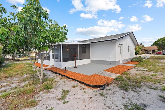 8510 SE Citrus Way, Hobe Sound, FL 33455 - rear view of property featuring a sunroom and stucco siding