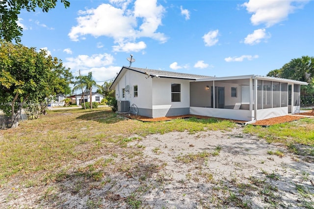 8510 SE Citrus Way, Hobe Sound, FL 33455 - back of house with a sunroom, stucco siding, and central air condition unit