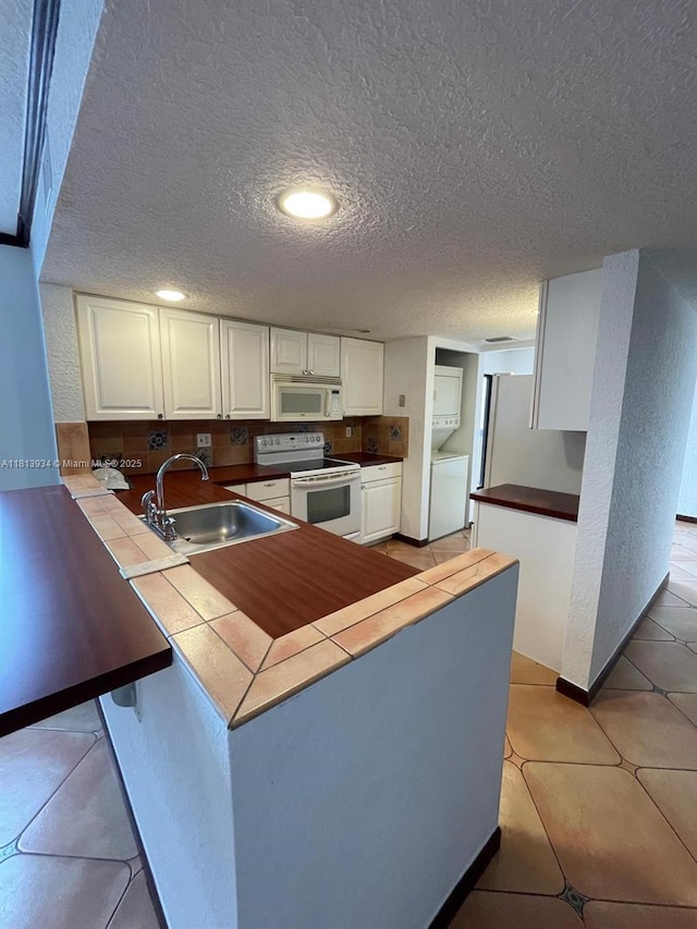 6575 W Oakland Park Blvd Unit 511, Lauderhill, FL 33313 - kitchen with white appliances, a sink, tile countertops, white cabinetry, and a textured ceiling