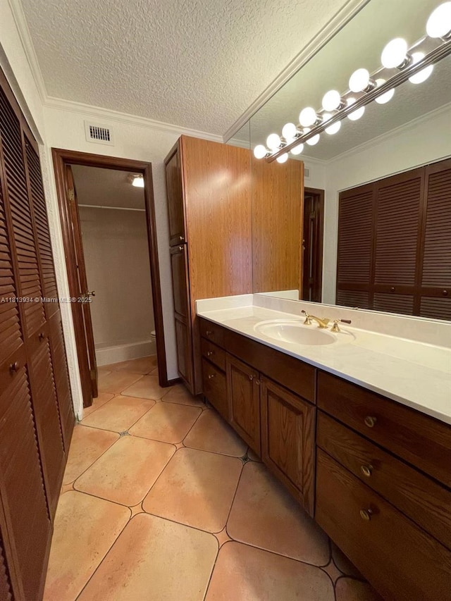 6575 W Oakland Park Blvd Unit 511, Lauderhill, FL 33313 - bathroom featuring a closet, vanity, a textured ceiling, tile patterned floors, and ornamental molding