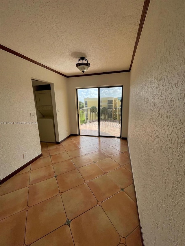 6575 W Oakland Park Blvd Unit 511, Lauderhill, FL 33313 - spare room featuring a textured wall, crown molding, a textured ceiling, baseboards, and light tile patterned floors