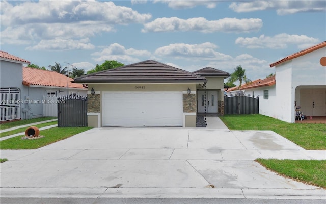 14945 SW 38th St, Miami, FL 33185 - mediterranean / spanish house with a gate, stone siding, an attached garage, stucco siding, and concrete driveway