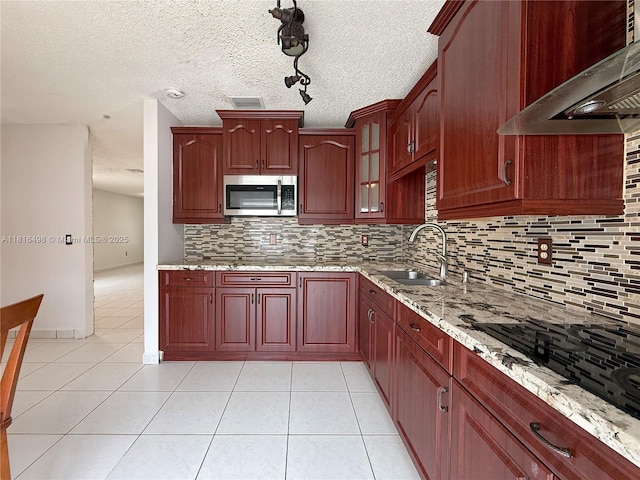 14945 SW 38th St, Miami, FL 33185 - kitchen with stainless steel microwave, wall chimney range hood, a sink, light stone counters, and tasteful backsplash
