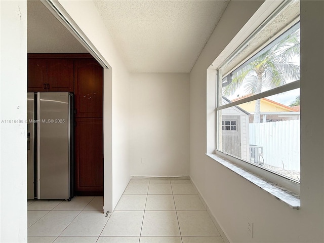 14945 SW 38th St, Miami, FL 33185 - spare room with a textured ceiling, light tile patterned floors, and baseboards
