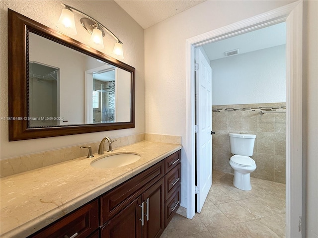 14945 SW 38th St, Miami, FL 33185 - bathroom with vanity, toilet, tile patterned floors, a textured ceiling, and tile walls