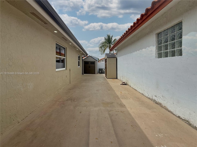 14945 SW 38th St, Miami, FL 33185 - view of home's exterior with stucco siding, a patio area, central AC, and a tile roof