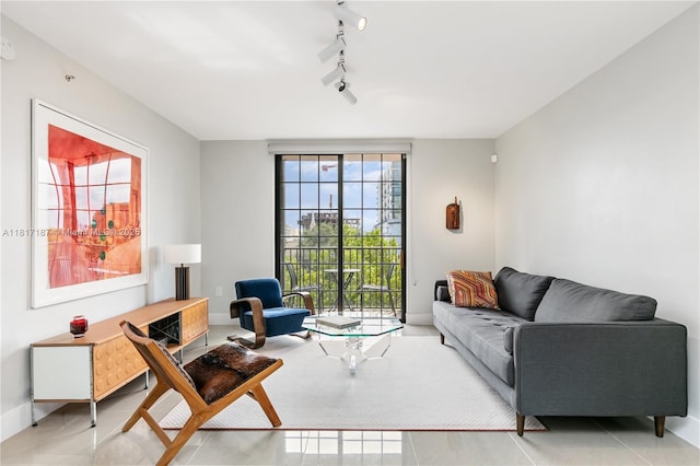 1900 Van Buren St Unit 407B, Hollywood, FL 33020 - living room with baseboards, rail lighting, and tile patterned flooring