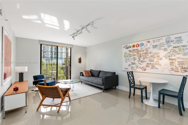 1900 Van Buren St Unit 407B, Hollywood, FL 33020 - living room with rail lighting, light tile patterned floors, and baseboards
