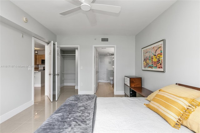 1900 Van Buren St Unit 407B, Hollywood, FL 33020 - bedroom featuring a closet, connected bathroom, a walk in closet, light tile patterned floors, and ceiling fan