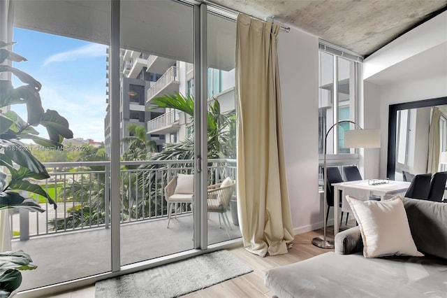 300 S Australian Ave Unit 302, West Palm Beach, FL 33401 - bedroom featuring wood finished floors, access to exterior, and floor to ceiling windows