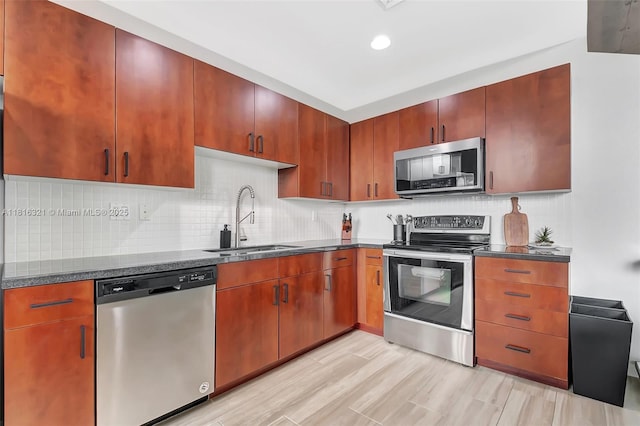 300 S Australian Ave Unit 302, West Palm Beach, FL 33401 - kitchen with appliances with stainless steel finishes, a sink, backsplash, light wood finished floors, and recessed lighting