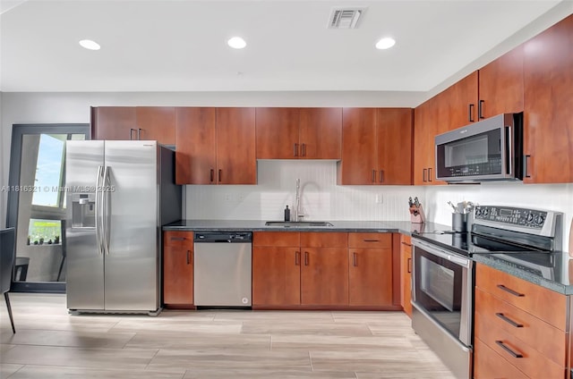 300 S Australian Ave Unit 302, West Palm Beach, FL 33401 - kitchen with appliances with stainless steel finishes, a sink, tasteful backsplash, recessed lighting, and dark stone counters
