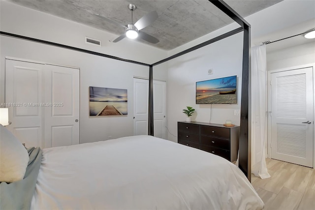 300 S Australian Ave Unit 302, West Palm Beach, FL 33401 - bedroom featuring multiple closets, light wood-type flooring, and ceiling fan