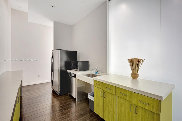 300 S Australian Ave Unit 302, West Palm Beach, FL 33401 - kitchen with appliances with stainless steel finishes, a sink, dark wood-style flooring, light countertops, and baseboards