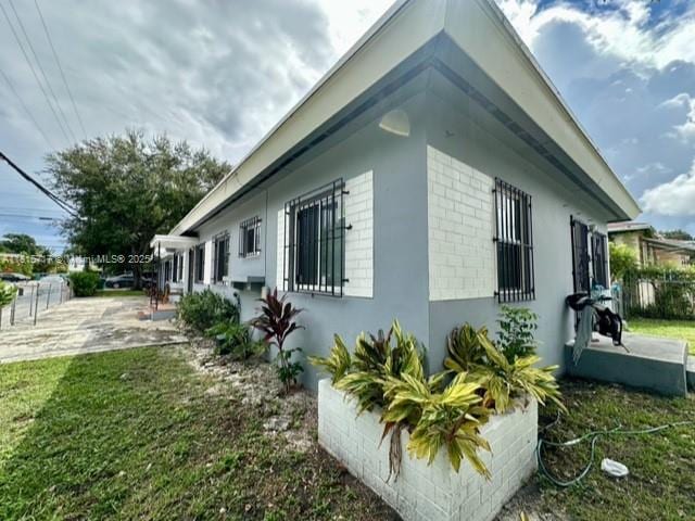 248 NW 69th St, Miami, FL 33150 - view of side of property featuring a yard