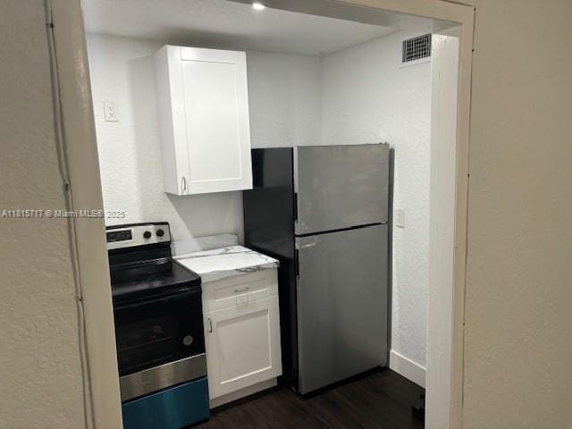 248 NW 69th St, Miami, FL 33150 - kitchen featuring stainless steel appliances, light countertops, white cabinets, dark wood-style floors, and a textured wall