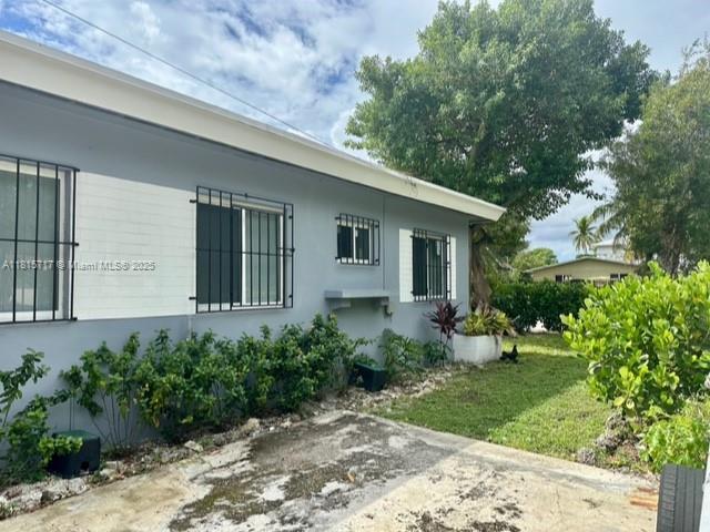 248 NW 69th St, Miami, FL 33150 - view of side of property with stucco siding