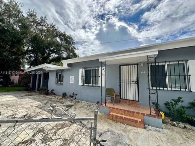 248 NW 69th St, Miami, FL 33150 - view of front facade featuring stucco siding and covered porch