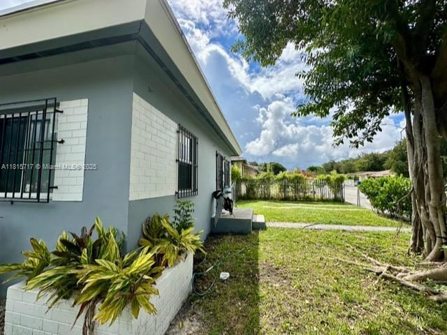 248 NW 69th St, Miami, FL 33150 - view of home's exterior with brick siding and stucco siding