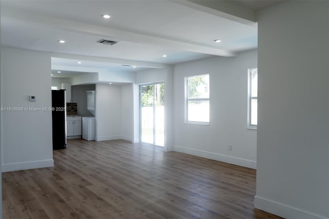 3613 SW 12th Pl, Fort Lauderdale, FL 33312 - unfurnished living room with beamed ceiling, baseboards, wood finished floors, recessed lighting, and washer / dryer
