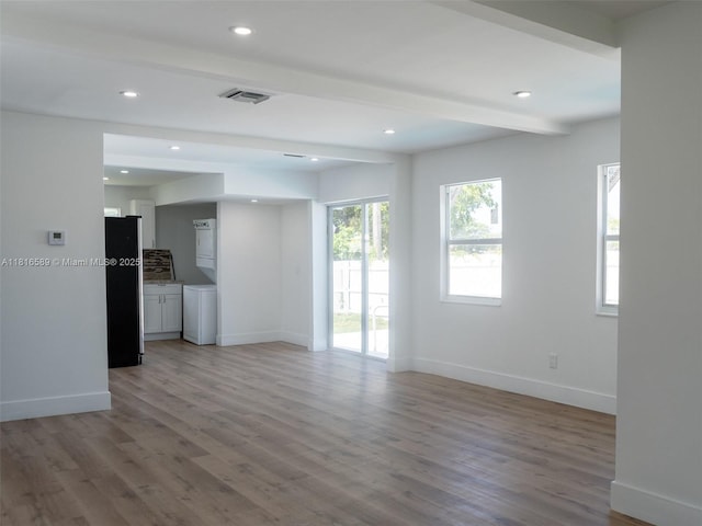 3613 SW 12th Pl, Fort Lauderdale, FL 33312 - unfurnished living room with beamed ceiling, baseboards, wood finished floors, recessed lighting, and washer / dryer