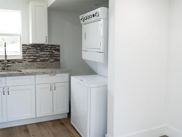 3613 SW 12th Pl, Fort Lauderdale, FL 33312 - laundry area with stacked washer and clothes dryer and light wood-style flooring