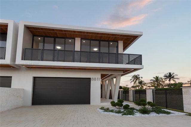 8811 SW 56th St, Miami, FL 33165 - view of front of house featuring a garage, a balcony, stucco siding, and decorative driveway