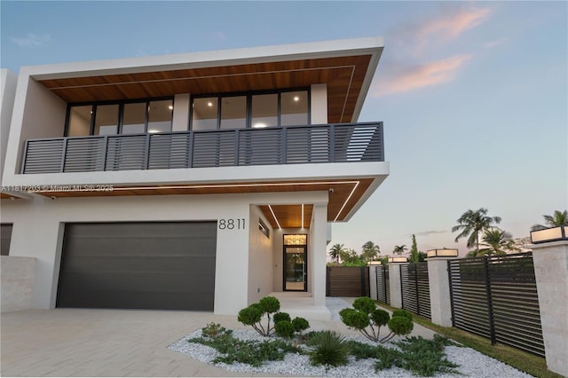 8811 SW 56th St, Miami, FL 33165 - modern home featuring a balcony, an attached garage, stucco siding, and driveway
