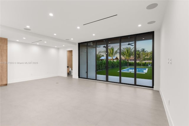 8811 SW 56th St, Miami, FL 33165 - spare room with recessed lighting, expansive windows, and baseboards