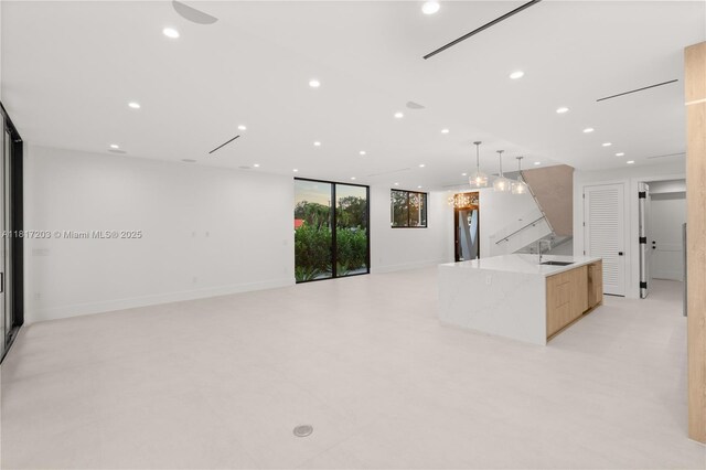 8811 SW 56th St, Miami, FL 33165 - kitchen featuring modern cabinets, a sink, a spacious island, recessed lighting, and open floor plan