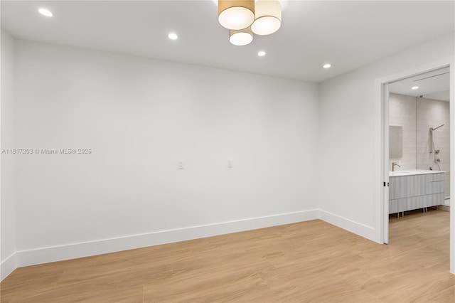 8811 SW 56th St, Miami, FL 33165 - empty room with light wood finished floors, recessed lighting, baseboards, and a sink